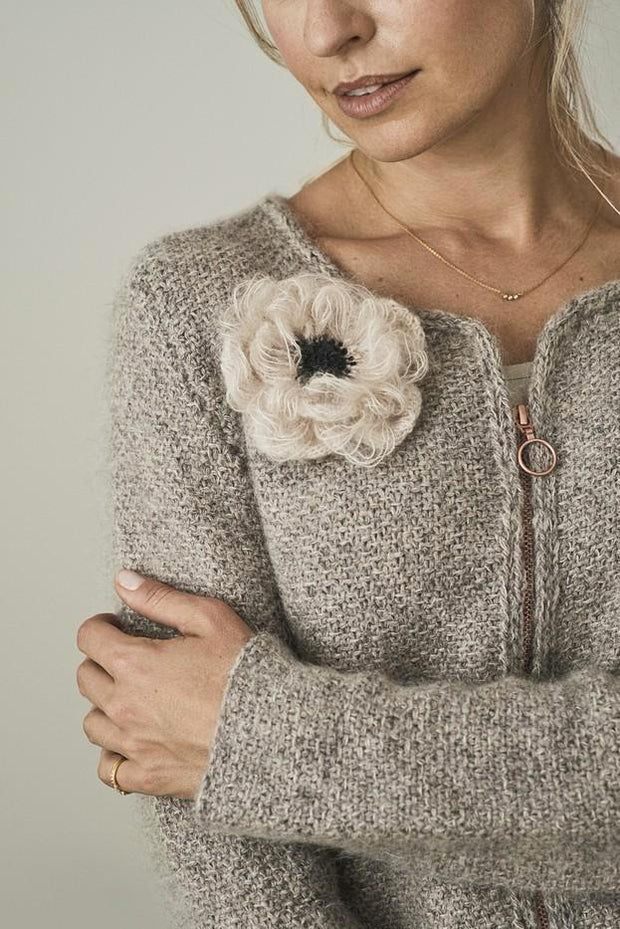 Aura knitted cardigan with pocket and a flower attached, made in grey Jensen yarn and silk mohair, the front