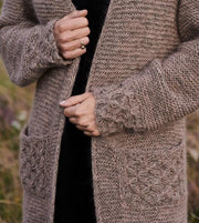 Beatrice long, cozy brown cardigan with smock pattern at hem, sleeves and pockets, made in Isager Alpaca and silk mohair