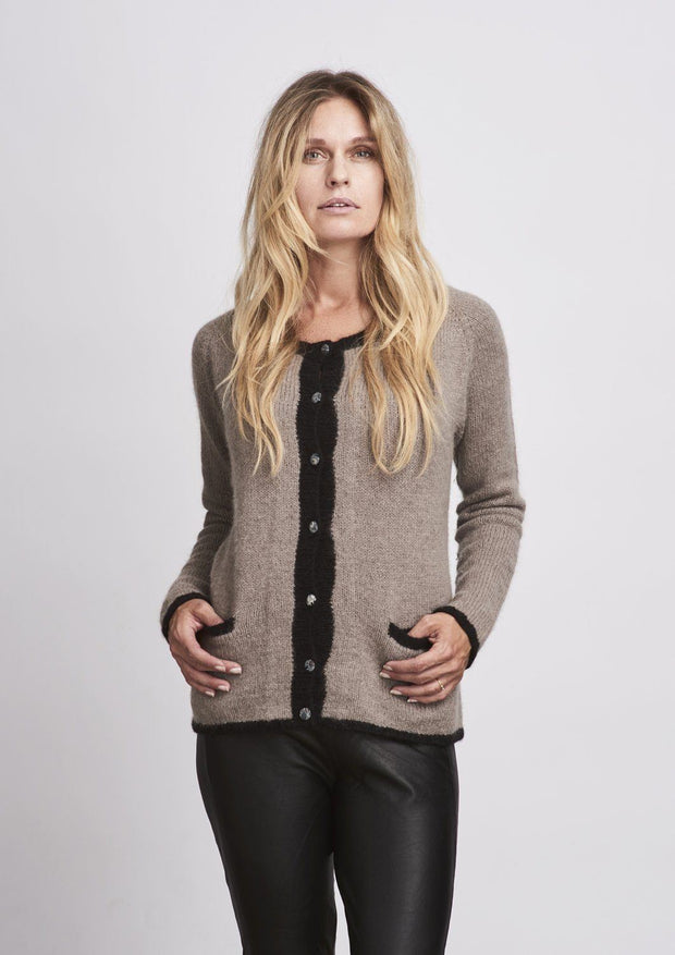 Classic knitted beige cardigan with liberty buttons and pockets, made in Önling no 1 merino wool, the front